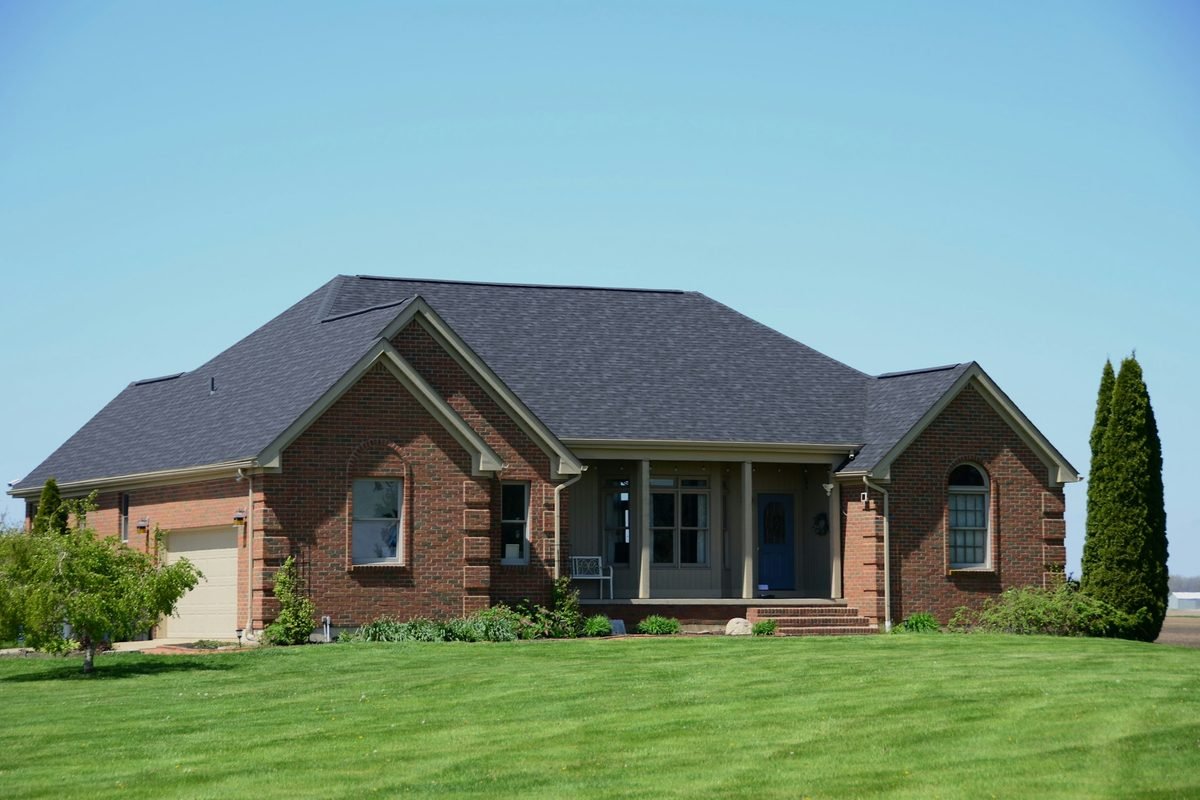 Single-story brick ranch house with a green lawn, typical of homes across Dallas-Fort Worth